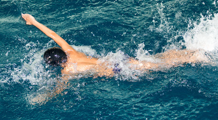 boy goes in for sports in the pool