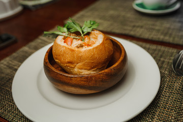 Hot Hungarian goulash soup in a loaf at restaurant
