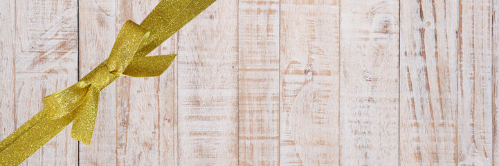 decorative gold ribbon on a old wood background