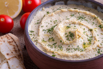 Humus in homemade bowl chapati and vegetable.