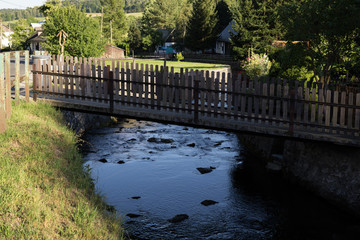 Fototapeta na wymiar Water stream in the small village in nature. Czech Republic