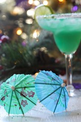 Cocktail umbrella on festive background, selective focus