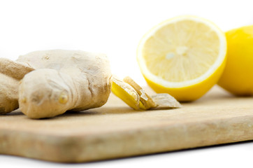 Sliced Ginger And Cutted On Half Lemon On White Background On Wooden Table Close Up