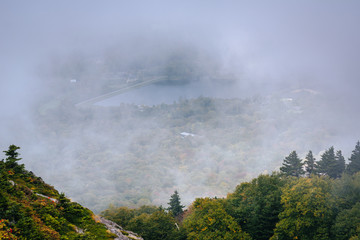 Fototapeta premium View of Grandfather Lake in fog, from Grandfather Mountain, Nort