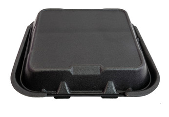 Closed disposable black styrofoam food container. Isolated.