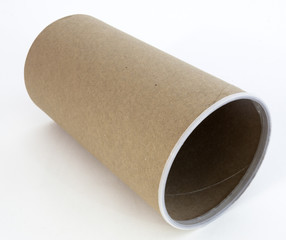 Empty cardboard packaging canister on its side.