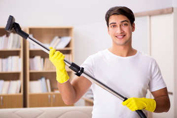 Man cleaning home with vacuum cleaner