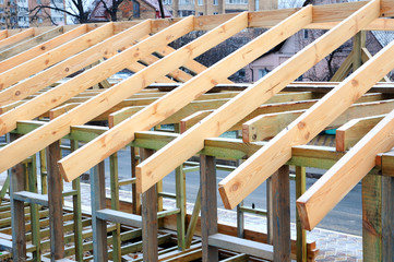 The wooden structure of the building. Wooden frame building. Wooden roof construction. photo for...