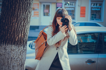 fashionable woman with a camera