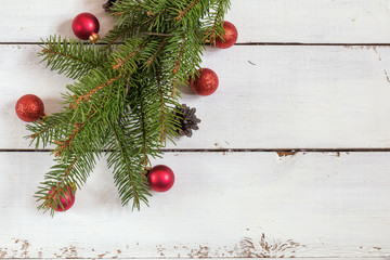 Christmas fir tree with decoration on white wooden board