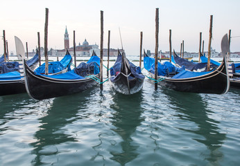 Fototapeta premium Long exposure of gondolas docked near St Marc square in Venice, Italy.