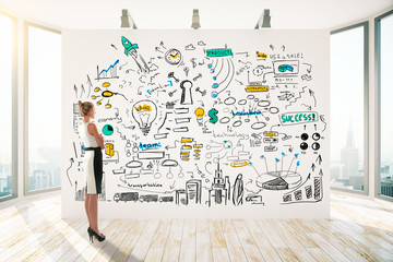 Fototapeta premium Businesswoman looking at business sketch