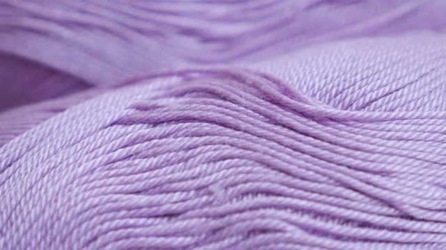 Pink yarn of wool wrapped in loose twist close-up 4K 2160p 30fps UltraHD panning footage - Knitting wool skeins shallow DOF slow pan 3840X2160 UHD video