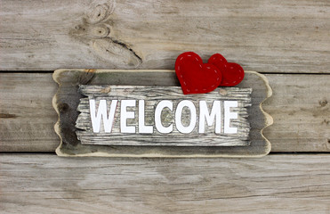 Rustic welcome sign with two red fabric hearts