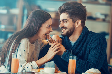 Young couple eating breakfast in the cafe