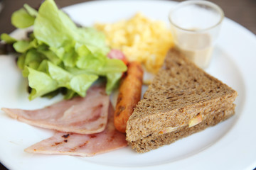 Breakfast with ham , fried egg and bread