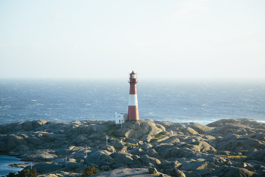 lighthouse Eigeroy Fyr on the rocky coast in Norway