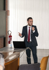 Young man in the classroom during the dissertation for his doctorate