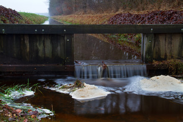 Wooden dam in canal, controlling the water level