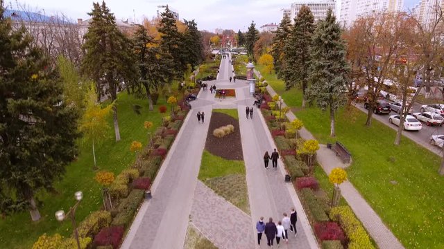 Aerial view of the russian southern city - Krasnodar. A pedestrian path. City park. Triumphal arch. King's gate. 4K