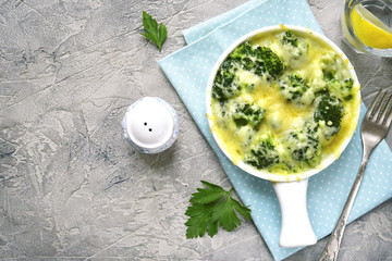 Broccoli gratin in a white baking dish .Top view with copy space