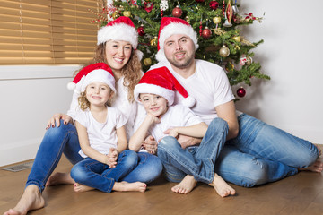 Fototapeta na wymiar Happy family celebrating christmas at home