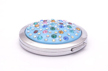 round pocket mirror with diamonds isolated on white