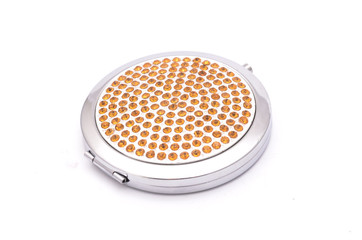 round pocket mirror with diamonds isolated on white