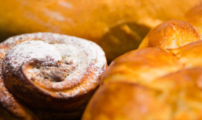 Closeup freshly baked cinnabon with powdered sugar coating, as seen from above, pastry concept