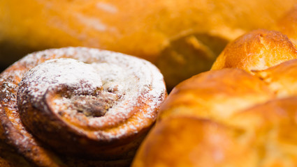 Closeup freshly baked cinnabon with powdered sugar coating, as seen from above, pastry concept