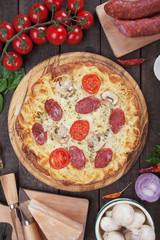 Spaghetti pizza with salami and mushrooms