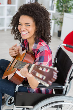Disabled lady playing guitar