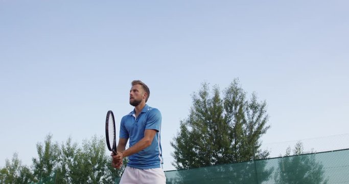  Low Angle Slow-Mo: Tennis Player Concentrates And Hits Backhand