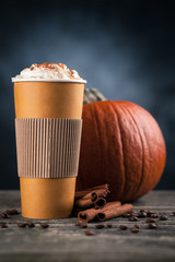 Pumpkin spice latte in a paper cup