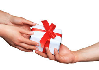 Male and female hands with white gift box with bow over white