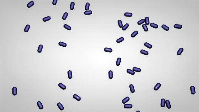 Blaue Tabletten fallen von oben auf einen Tisch