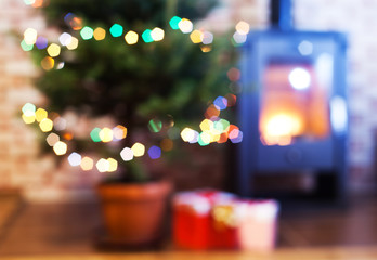 blurred background of decorated Christmas tree and fireplace