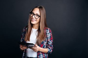 Joyful young woman using tablet