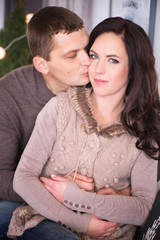 Beautiful young couple relaxing in a living room with new year t