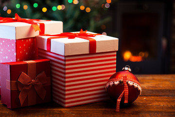 festive red Gift Boxes by the Burning Fireplace