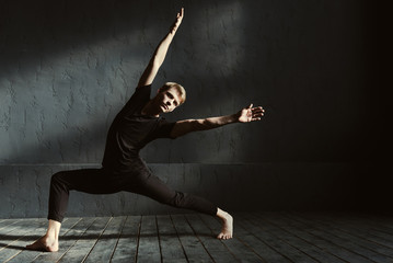 Skillful dancer training in the dark lighted room