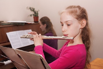 girl learning to play the flute