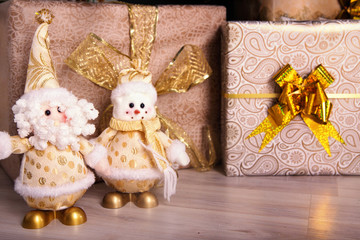 Christmas presents under the fir on the floor. Santa and snowman