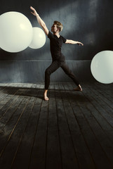 Fototapeta na wymiar Talented ballet dancer acting in the decorated studio