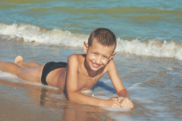 Happy  little boy having fun on the beach