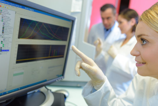 medical scientists using digital machinery at laboratory