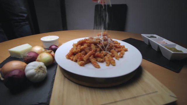 Hot Pasta with tomato Sauce, Parmesan Cheese on a Spoon