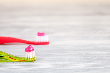 children's toothbrush oral care on wooden background