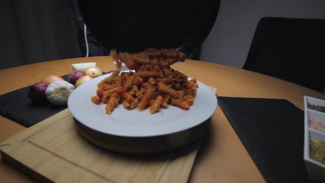 Hot Pasta with tomato Sauce, Parmesan Cheese on a Spoon