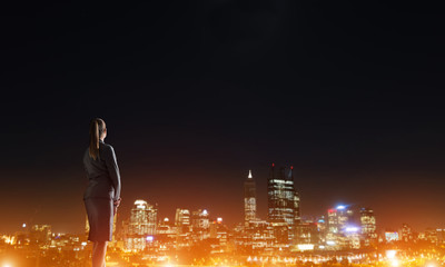 Woman looking at night city